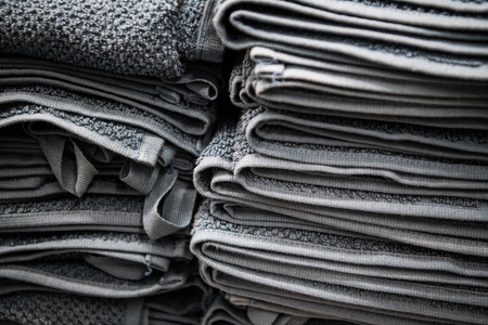 Natural pure linen towels, napkins on tablecloth. Small business. Pile of striped white grey linen cotton fabrics on fabric background. Food photo props.の写真素材