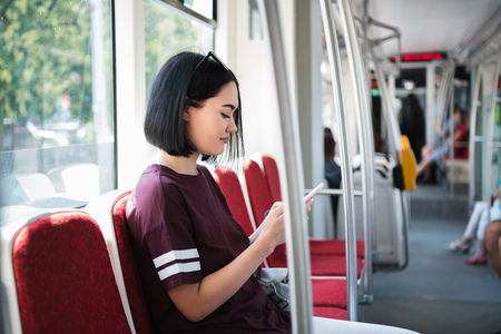 Girl on her phone while travelling on the bus.の写真素材