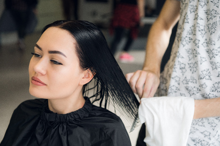 Attractive woman smiling while having a consultation with her hair stylist.の写真素材