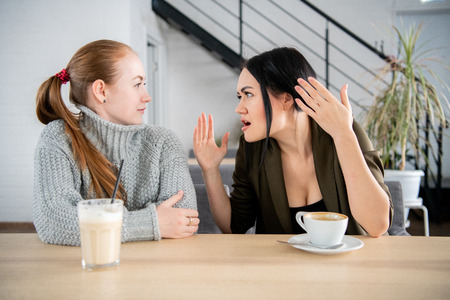 Woman friends sit and feel upset in the restaurant