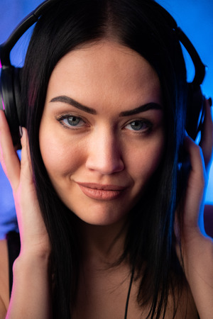 Sexy young girl DJ wearing headphones close portrait.の写真素材