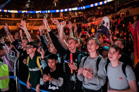 MOSCOW, RUSSIA - 14th SEPTEMBER 2019: esports event of a Counter Strike game. A lot of fans on a tribune at tournaments arena with hands raised. Cheering for their favorite team.のeditorial素材