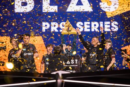 MOSCOW, RUSSIA - 14th SEPTEMBER 2019: esports gaming event. The winner of tournament team Avangar on a stage with a main trophy - big cup celebrating a victory.のeditorial素材