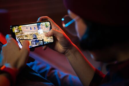 MOSCOW, RUSSIA - December 2019: Playing a PUBG Mobile battle royale games on Apple Iphone 11 Pro...