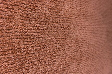 Red artificial carpet texture close-up, top viewの写真素材