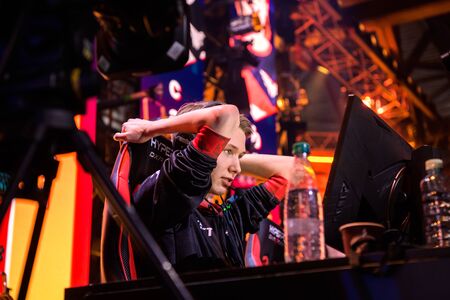 MOSCOW - DECEMBER 23 2019: esports Counter-Strike: Global Offensive event. Cyber sports professional Martin stavn Lund on a stage playing tournament game, looking at screen.のeditorial素材