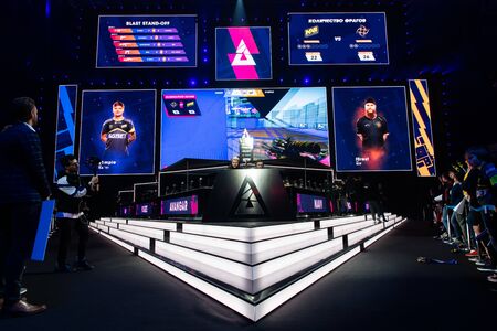 MOSCOW, RUSSIA - 14th SEPTEMBER 2019: esports Counter-Strike: Global Offensive event. Stage of a computer games tournament located on a big stadium. Players booths and big screens with game moments on it.のeditorial素材