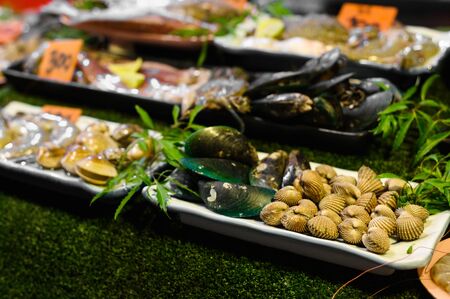 Traditional asian night market with delicious seafood and exotic food for tourist. Shell and...