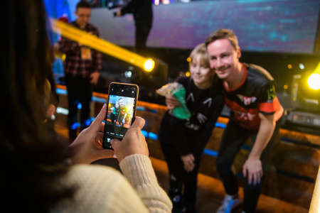 MOSCOW - DECEMBER 23 2019: esports Counter-Strike: Global Offensive event. Happy dedicated games fan making a picture with danish professional player Casper cadiaN Moller.のeditorial素材