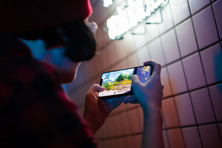 MOSCOW, RUSSIA - December 2019: Girl play PUBG: Mobile on iPhone 11 Pro smartphone close-upのeditorial素材