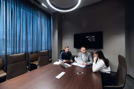 Coworkers meeting at conference room to discuss project in officeの写真素材