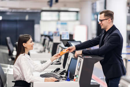 Young handsome businessman flirting with female receptionistの写真素材