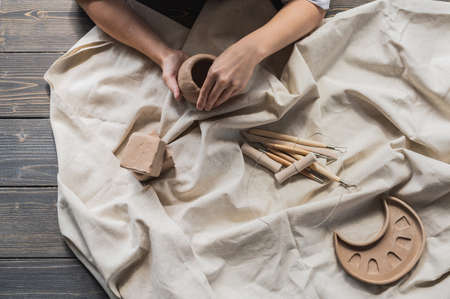 Table with materials and tools for pottery making craftsperson workspace creative studio top viewの写真素材