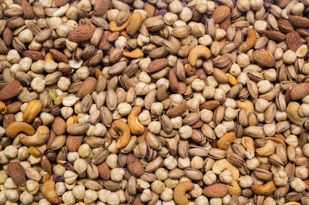 Mix of different nuts closeup photo to use as a texture or background.の写真素材