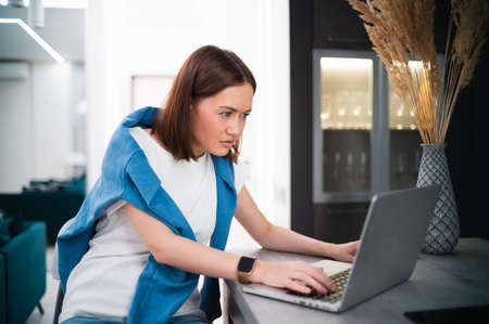 Portrait of gamer girl playing online game on a laptop from homeの写真素材