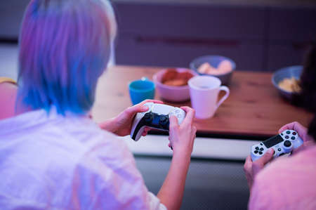 Portrait of emotional young couple playing video game at home.