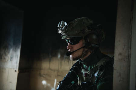 Soldier preparing tactical gear for action battleの写真素材