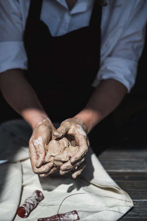 Close up picture of female ceramic artist arms in clay after making pottery.の写真素材