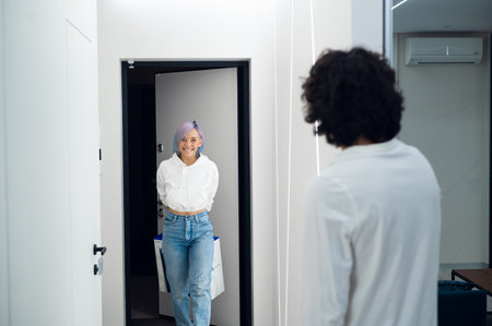 Happy excited woman comes home to make a surprise for her boyfriend with a brand new Sony PlayStation 5 gaming console she bought for christmas. Moscow - November 28 2020のeditorial素材