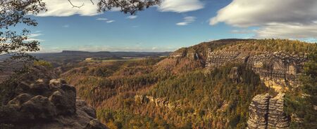landscape in mountains - panorama overlooking the valley with forests and sandstone rocks, national park Bohemian Switzerland, Czech republicの写真素材