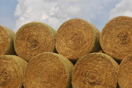 Stack of Straw Bales - Stack of Straw Bales Stacked on Top of Each Other, Blue Sky with White Clouds