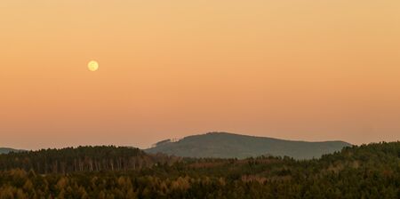 evening hilly landscape at full moonの写真素材