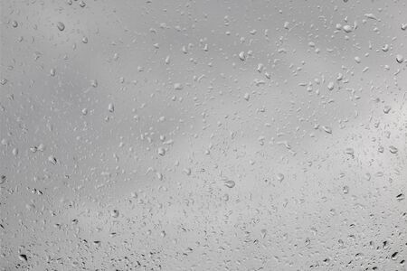 raindrops on the window - view out the window outwards, rainy weather, texture backgroundの写真素材