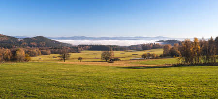 beautiful landscape with hills and forests, blue sky with clouds