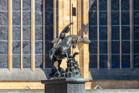Statue of Saint George in the Prague Castle, in background the windows of St. Vitus Cathedral, Prague, Czech republicのeditorial素材