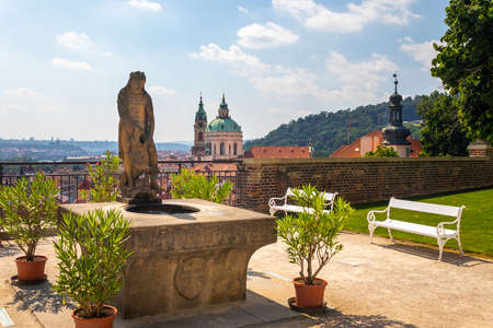 fountain with statue of Hercules in the garden, Prague Castle, view of the Church of St Nicholas, Czech republicのeditorial素材