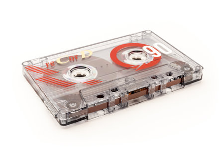 Audio cassette tape - old vintage compact audio cassette on its side isolated on white background,...