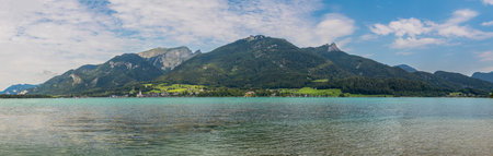 landscape with Lake Wolfgangsee, mountain Schafberg, Reiningspitz, Teufelhaus, Vormauerstein and the town of Sankt Wolfgang, Austriaの写真素材