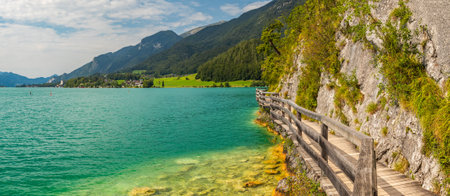 wooden walkway by the rock around Lake Wolfgangsee, Sankt Wolfgang, Austriaの写真素材