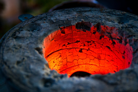 A closeup picture of a red hot oven for melting metalsの写真素材