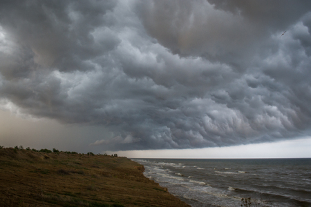 Storm front over water with wall of rain in the centreの写真素材