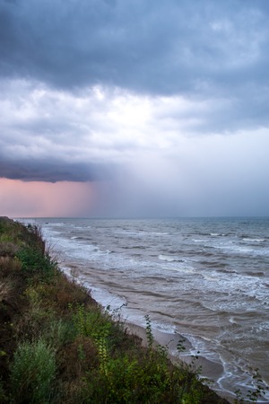 Storm front over water with wall of rain in the centreの写真素材