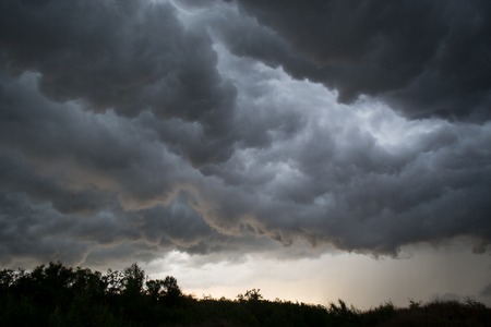 Horrifine clouds moving ahead of the storm being situated close to the groundの写真素材