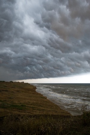 Storm front over water with wall of rain in the centreの写真素材