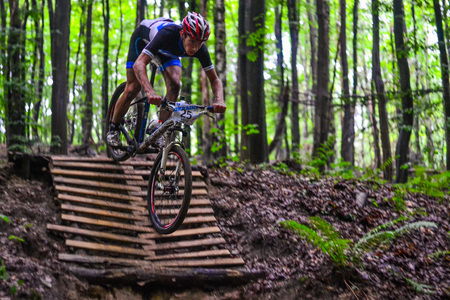 Lviv, Ukraine - August 17, 2016: MTB cyclist A. Pustovit competing in the forest near Lviv in Ukraine at 4th round of amateur xc cup of Ukraine 2016.のeditorial素材