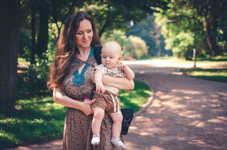 A happy mother with child resting in parkの写真素材
