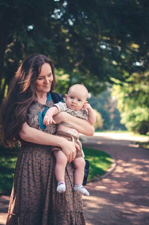 A happy mother with child resting in parkの写真素材