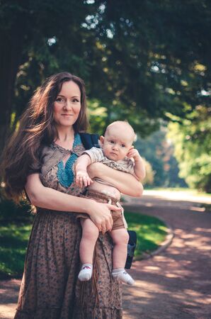 A happy mother with child resting in parkの写真素材