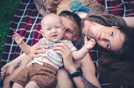 A happy family with child resting in park