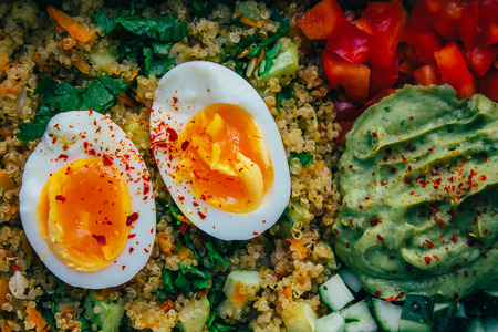 Cinoabowl with soft boiled half egg, guakamole, cucmber, pepperの写真素材