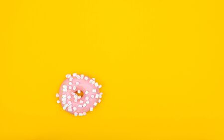 Sweet chocolate donut on yellow background. Dessert foodの写真素材