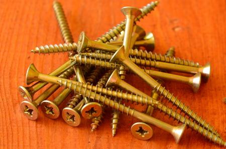 Screws on red background