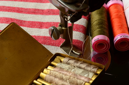 Vintage sewing machine and  thread spoolsの写真素材