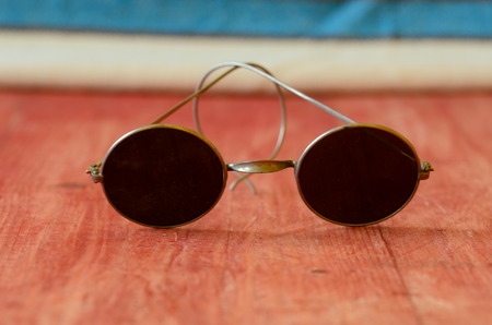 Retro sunglasses on brown wooden backgroundの写真素材