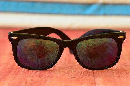 Retro sunglasses on brown wooden backgroundの写真素材