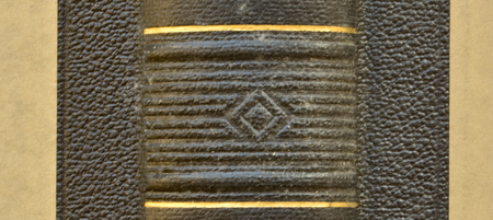 Closeup old book.  Back of vintage book with embossed texture.